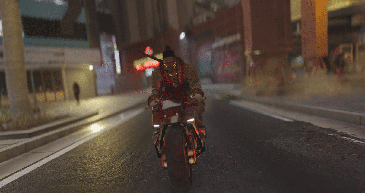 Person biking through a neon-lit street in Cyberpunk 2077's Night City.